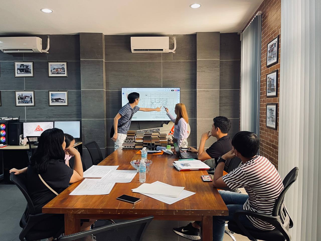 IG Sabroso team and clients reviewing a project plan together