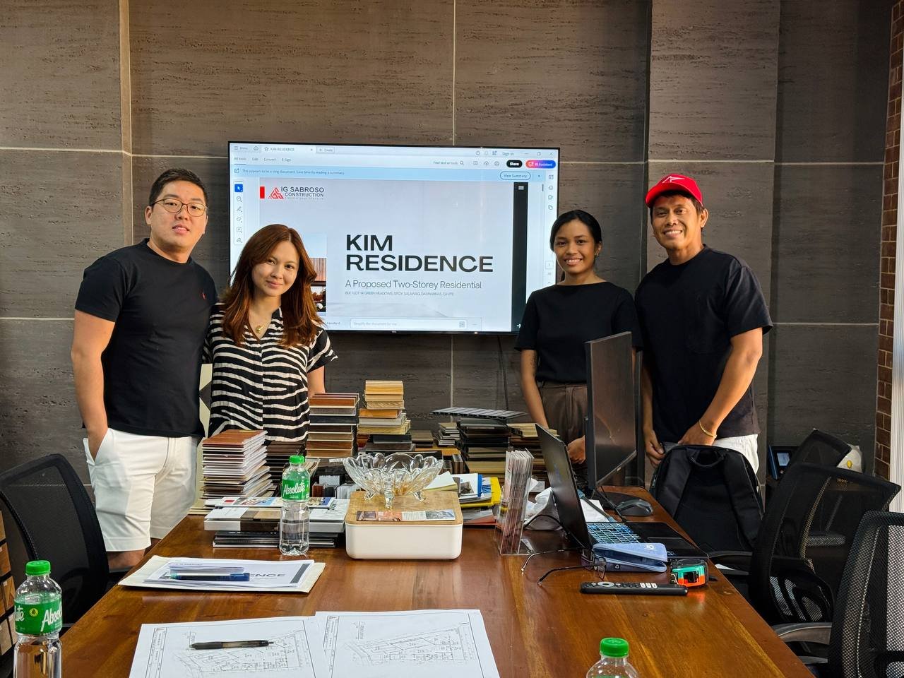 IG Sabroso team and clients reviewing the Kim Residence project presentation in a meeting room